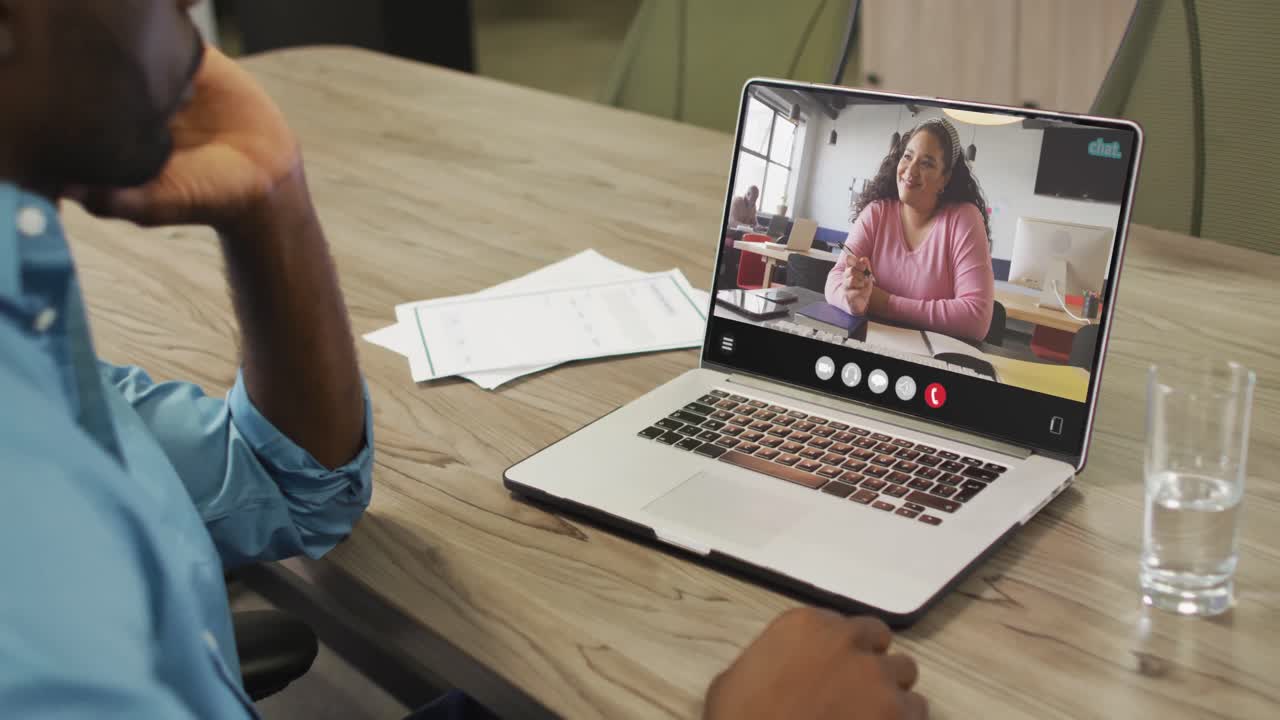 African american man using laptop for video call, with business colleague on screen