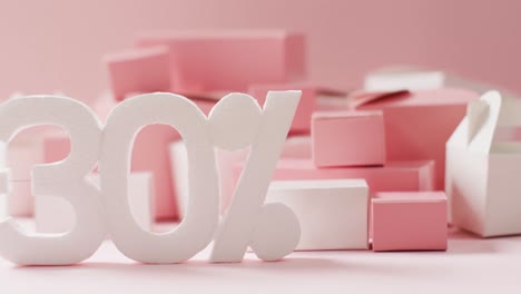 minus thirty per cent text in white with pink and white gift boxes on pink background