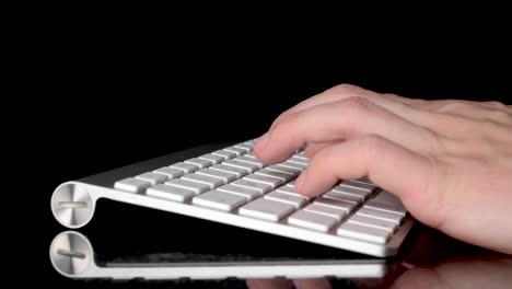 typing with two hands on isolated keyboard. close-up