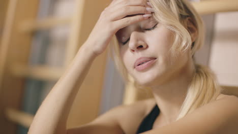 portrait of upset girl sitting in fitness gym.