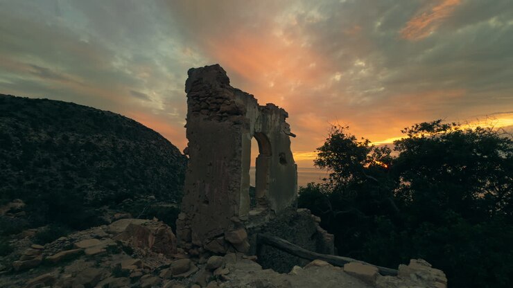 Ruined Arch at Sunset over Mountains