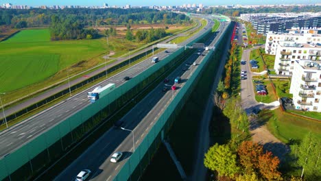 Beautiful-top-side-view-to-the-cars-driving-on-multi-level-highway-on-the-sunny-evening-in-Warsaw-Picturesque-aerial-panorama-of-the-road-traffic-and-sunset-city