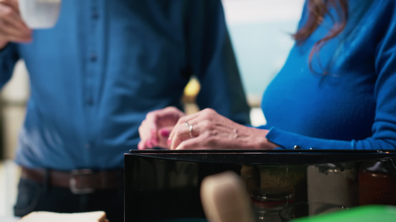 Senior couple prepares breakfast together in modern kitchen