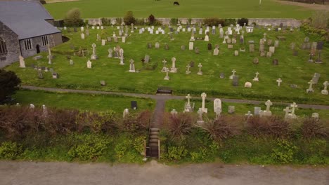 aerial pan across crantock churchyard cemetery graveyard