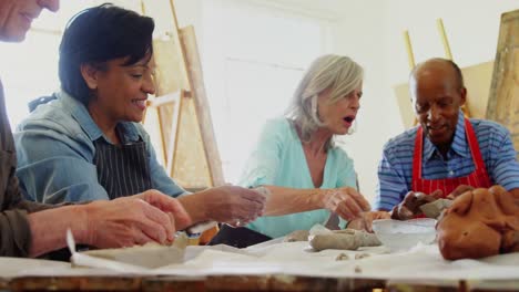 artist molding a clay at table 4k