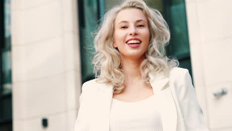 smiling woman in a white blazer