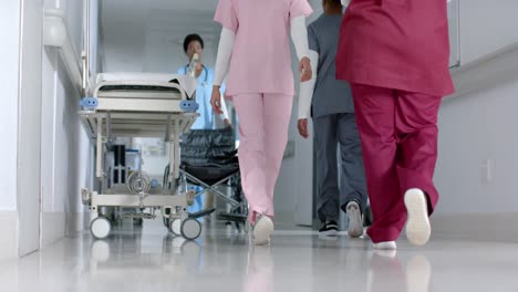 diverse doctors walking in corridor at hospital, slow motion