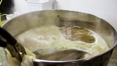 alcoholic beer frothing and steaming in pot at local brewery