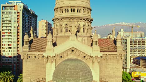 drone shot toward the sunlit facade of the sacramentinos church, in santiago de chile