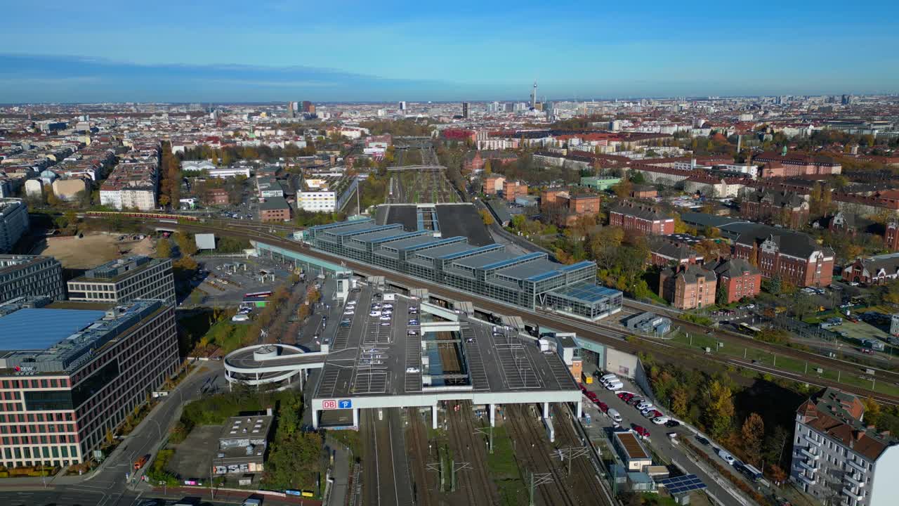 Berlin cityscape with a modern train station South Cross and extensive railway lines under a clear sky. Great aerial view flight panorama overview drone