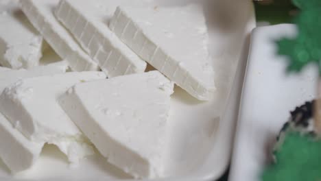 closeup of sliced white cheese on a plate