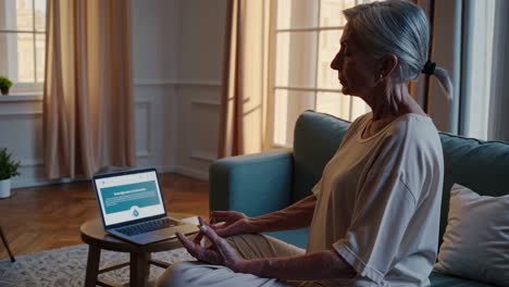 senior woman meditating online