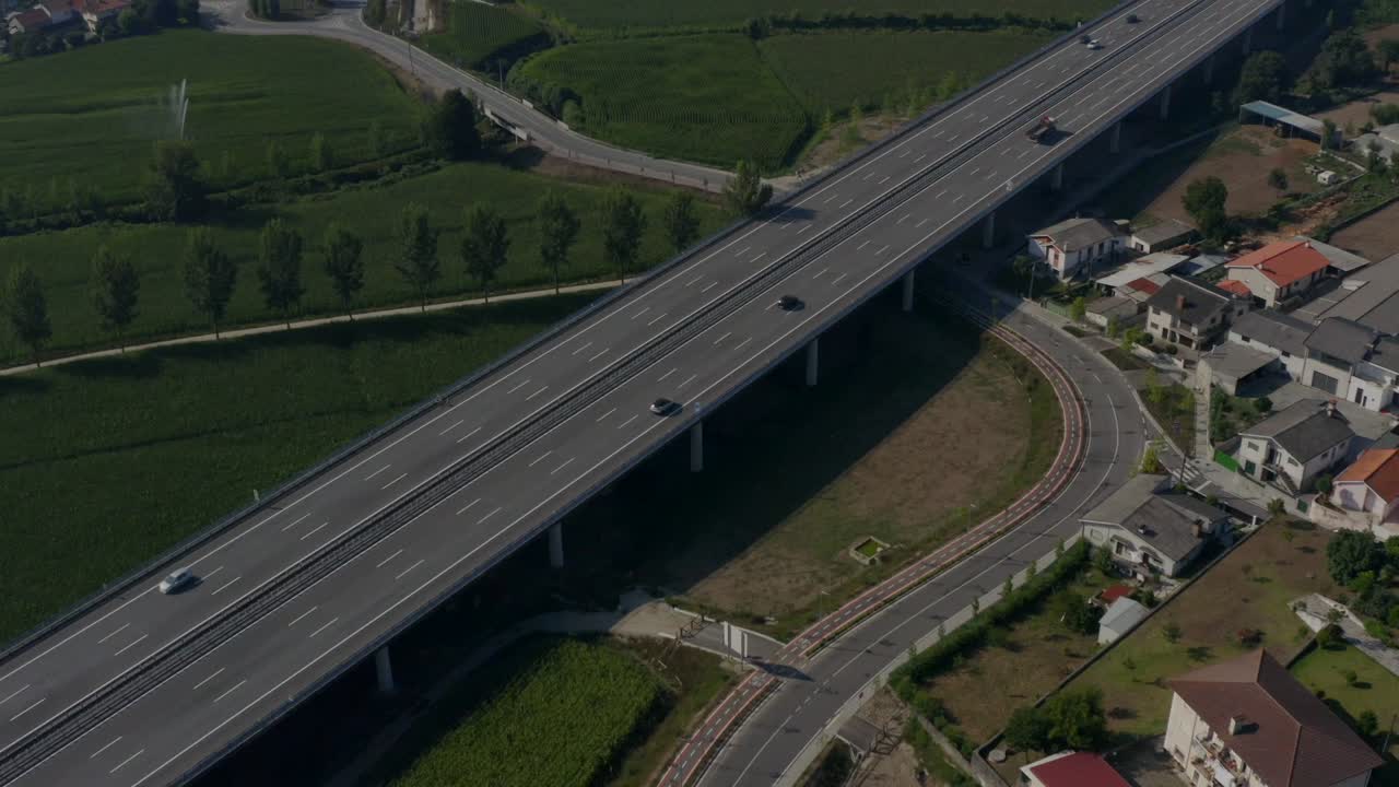Cars passing by on a highway in the countryside.