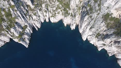 Beautiful-creek-from-vertical-top-view-by-drone.-Mediterranean-sea-along-cliffs