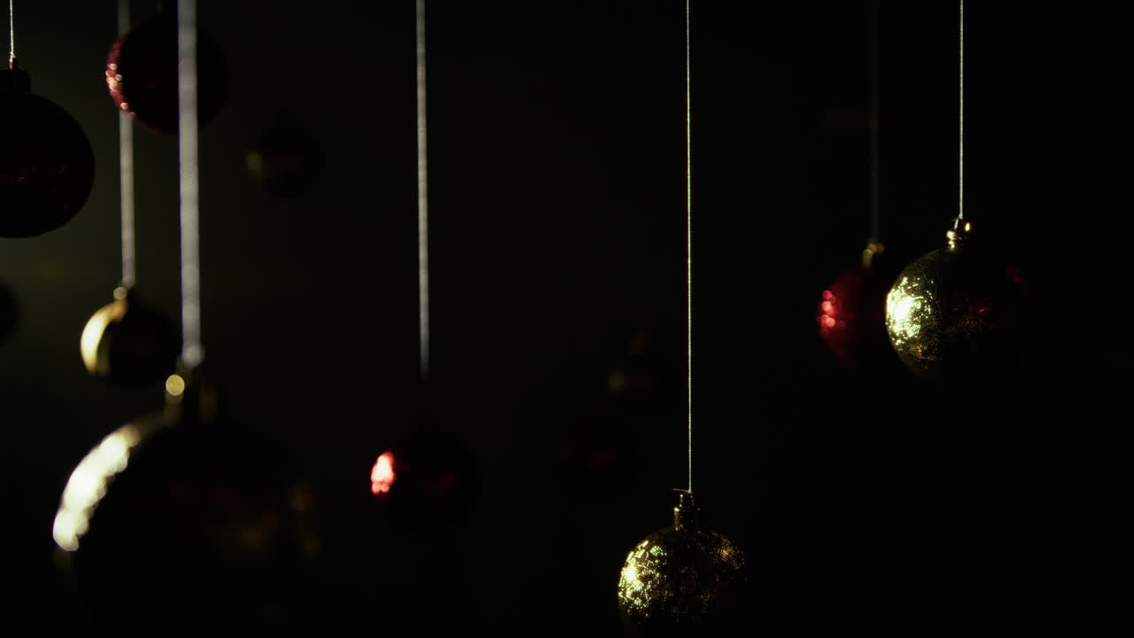 Melancholy Mourning Christmas balls hanging in a room on a black background