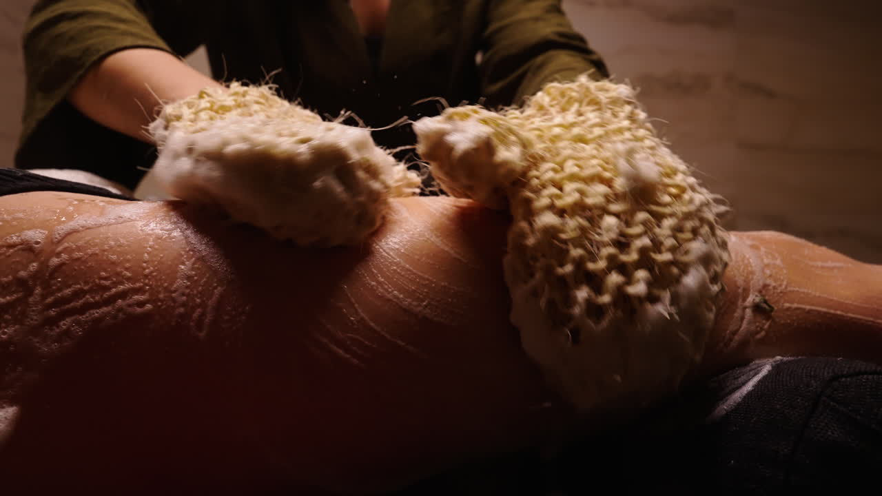 Woman getting a body scrub