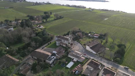 aerial of notre-dame church and vineyards, bayon-sur-gironde france