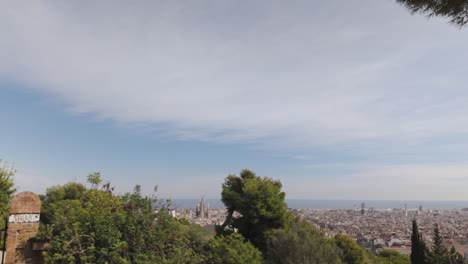white facade of casa trias with green roof tiles and balconies overlooking barcelona on a sunny day