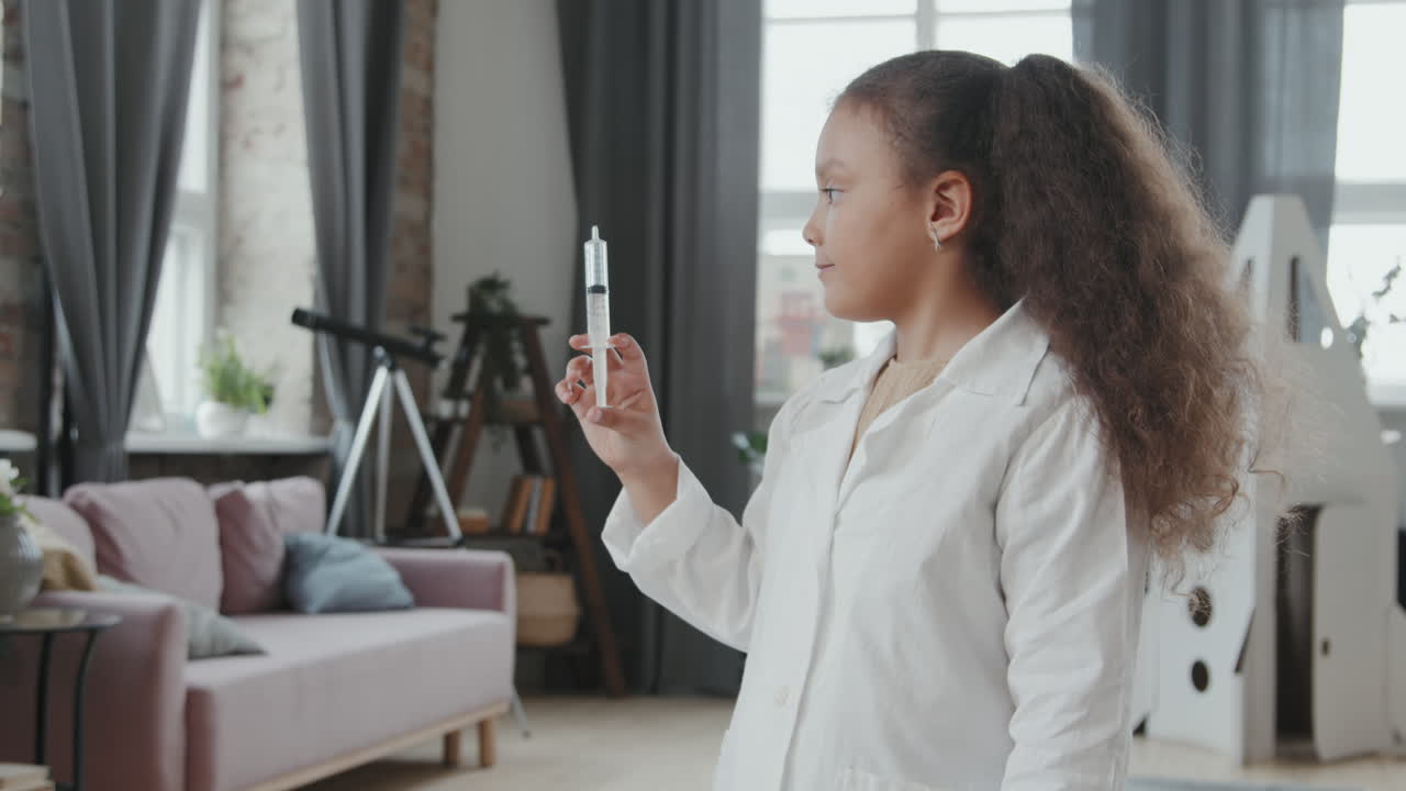 Cute Girl in Doctor Costume Posing with Syringe