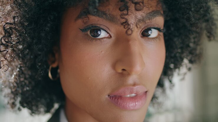 Closeup attractive woman face with beautiful dark eyes. African american girl.