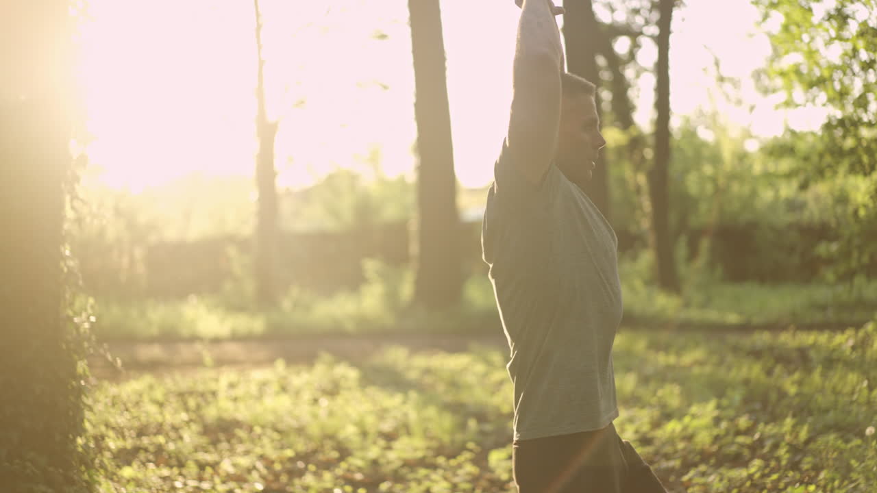 Man exercising and stretching in a forest