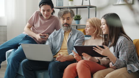 family using technology together at home