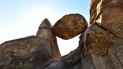 wait for it: time lapse of shadows creeping and then the bright sun peeks above this geological formation as it rises