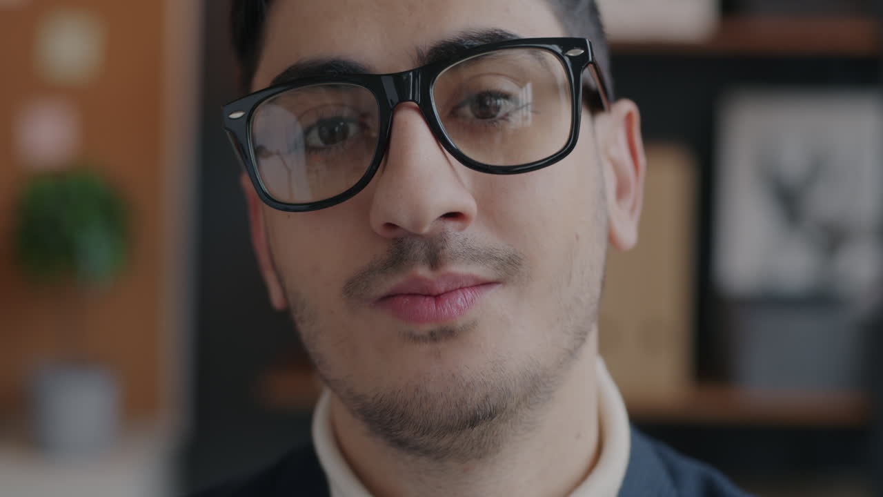 Close-up portrait of a smiling man wearing glasses