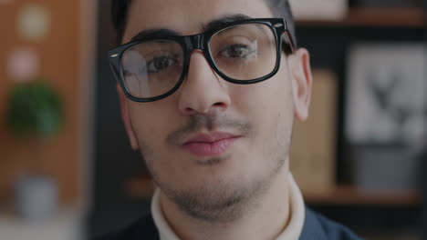 close-up portrait of a smiling man wearing glasses