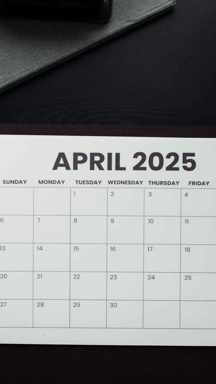 Person looking at calendar for April 2025