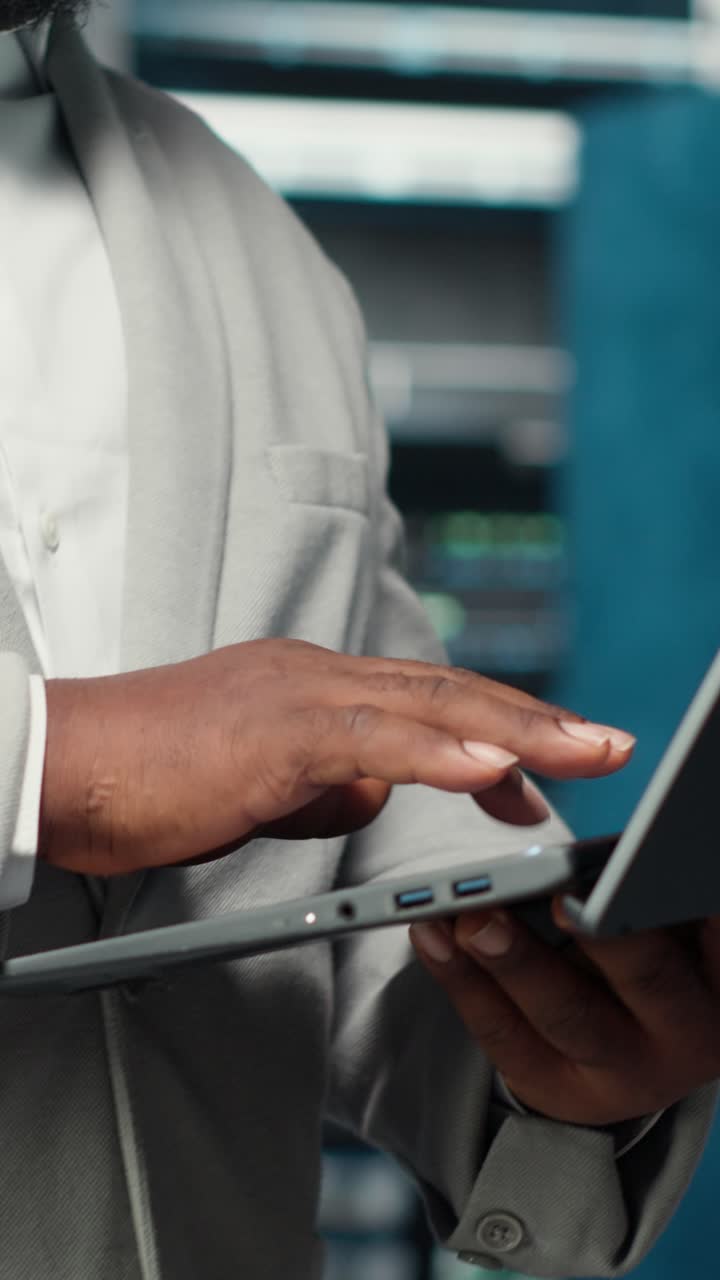 Vertical video Close up of engineer walking in data center workplace, checking gear