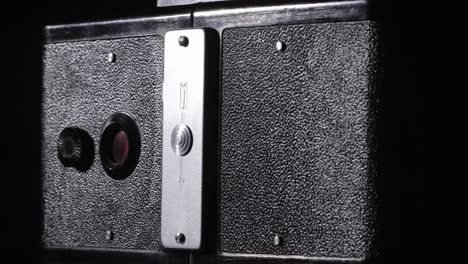 Vintage-stereo-photo-camera-on-black-background.Rotating