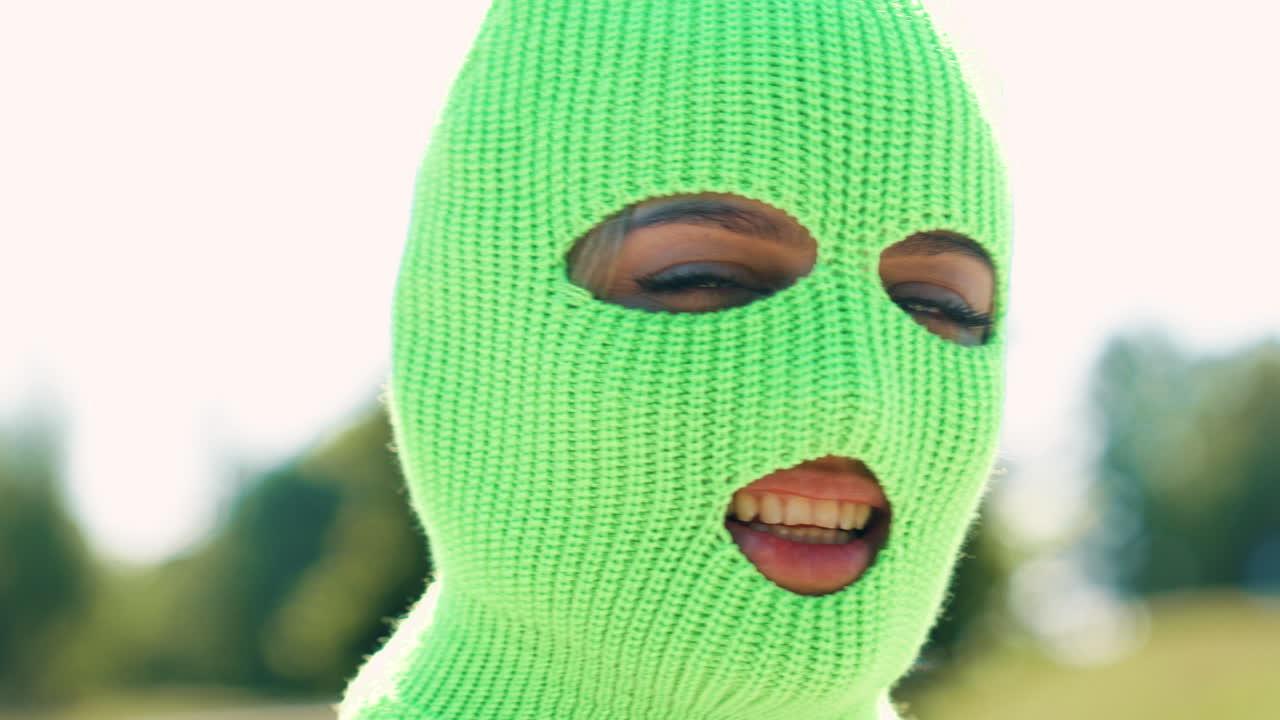 밝은 초록색 뜨개질 마스크를 입은 여자