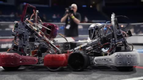 spectacular showdown: two advanced robots engage in a thrilling collision at a robotics competition, showcasing innovation and engineering skills in action