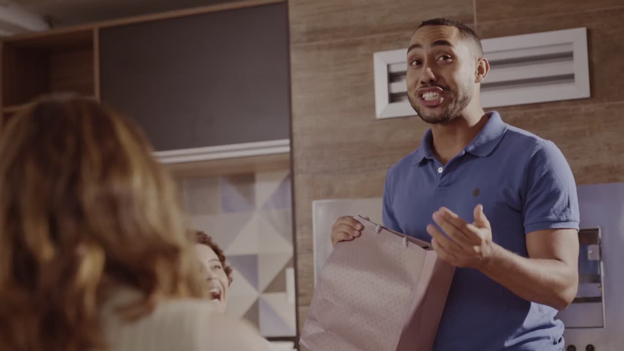Man holding a shopping bag and talking to someone