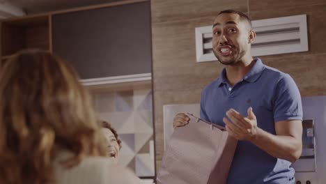 man holding a shopping bag and talking to someone