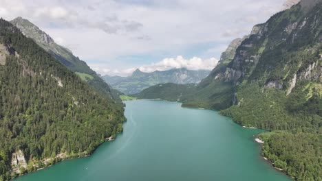 Aerial-view-of-picturesque-Klöntalersee-lake-in-the-Swiss-Alps,-Glarus-Süd,-showcasing-the-concept-of-natural-beauty-and-serenity