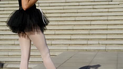 Female-ballet-dancer-listening-music-on-mobile-phone-4k