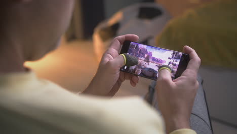 person playing a mobile game