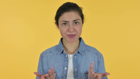 online video chat by young indian woman, yellow background