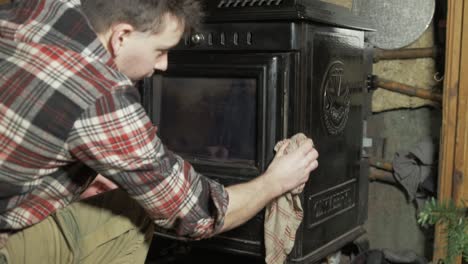 cleaning household stove with cleaning rag