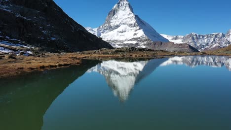 descending shot of matterhorn and blue stellisee lake