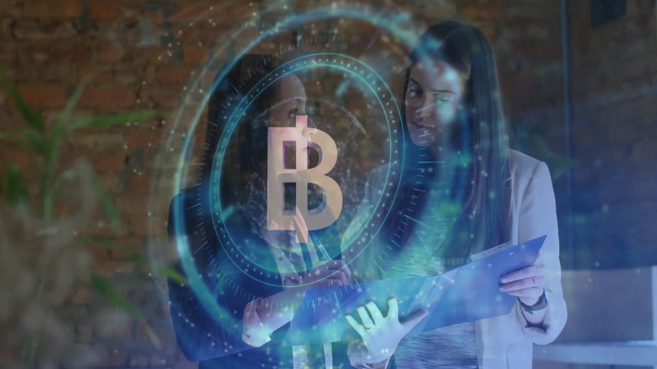 Women reviewing clipboard in office, showing holographic Bitcoin icon and animated finance chart