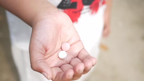 child holding pills