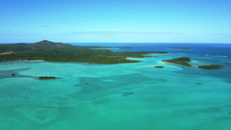 isle of pines new caledonia crystal clear waters and n'ga peak - stunning aerial flyover