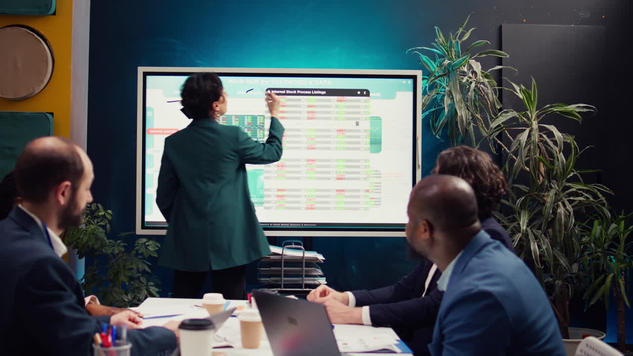 Team of business colleagues reviewing statistics and sales data