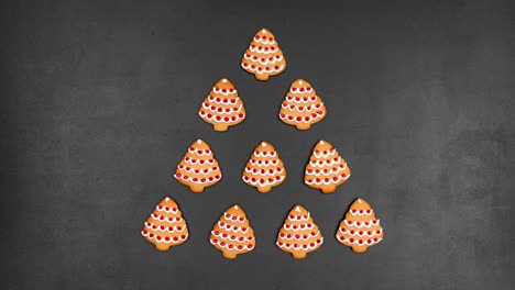 seamless looping stop motion animation with cookies shaped christmas tree on a black chalkboard background