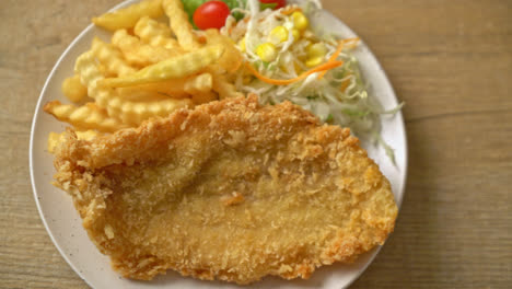 fried fish fillet and potatoes chips with mini salad