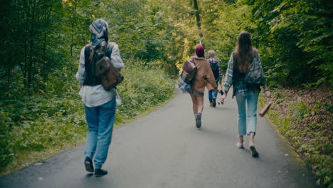 carefree male and female explorers walking in forest