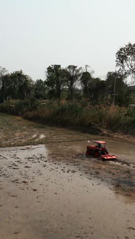 tractor working in a paddy field